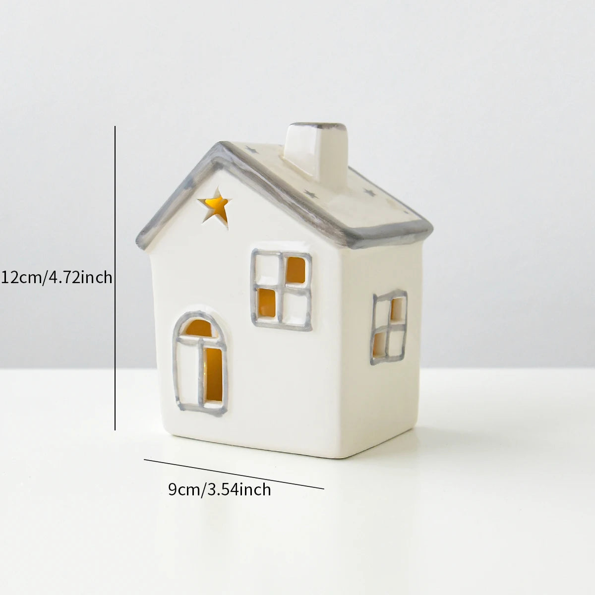 A grey roofed ceramic Christmas house with lights, designed to create a mini Christmas village scene.