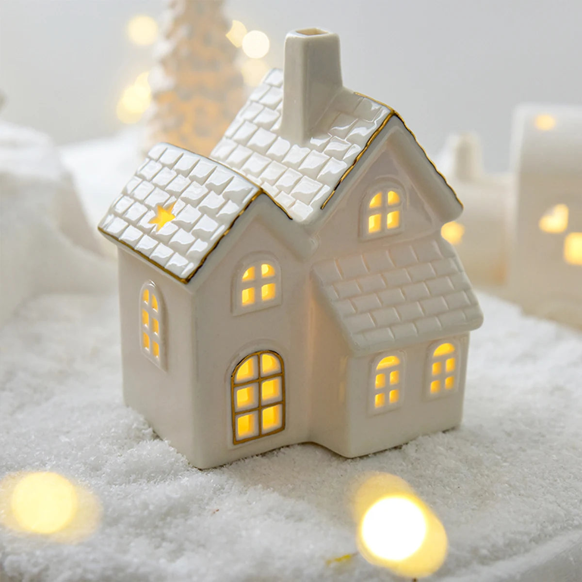 A ceramic Grand Vila Christmas house with lights, designed to create a mini Christmas village scene.