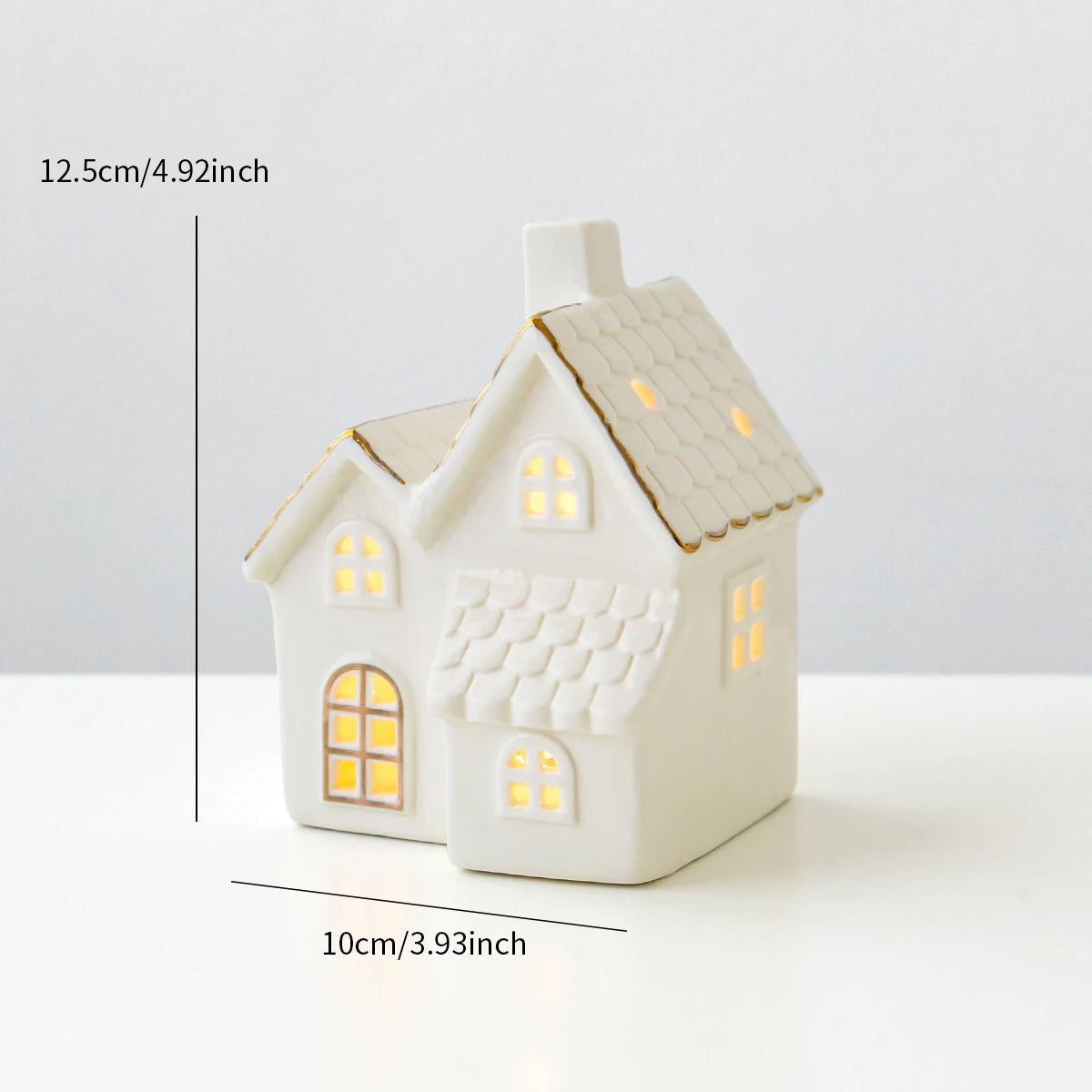 A ceramic Grand Vila Christmas house with lights, designed to create a mini Christmas village scene.
