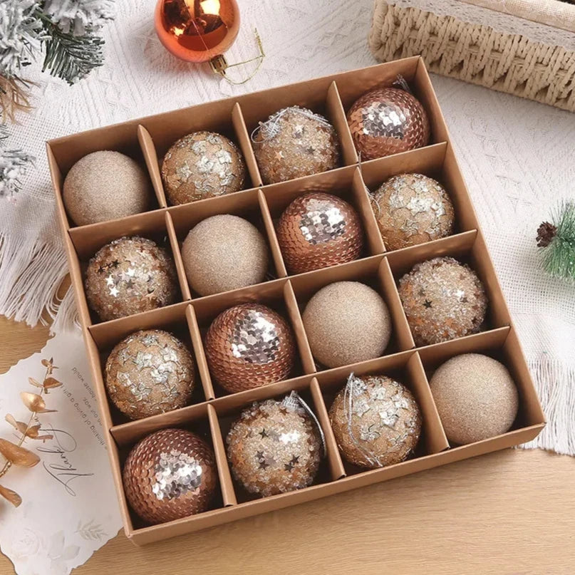 A set of 16 gold sparkly, textured Christmas baubles, presented in open cardboard box.