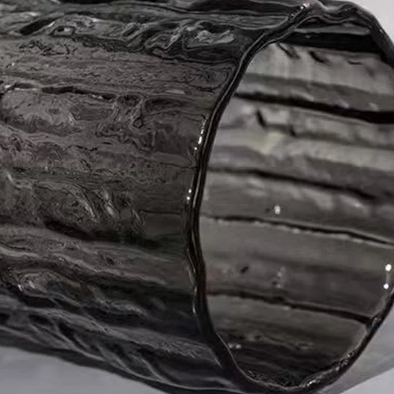 Close-up of a textured smoke grey glass vase neck showing the ripple glass effect