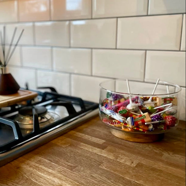 Glass bowl filled with candy on a kitchen counter