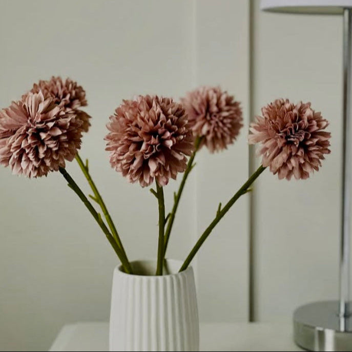 White vase with coffee pink artificial hydrangea flowers on a neutral background