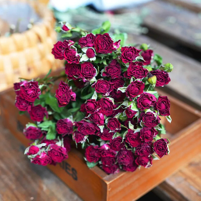 Bouquet of dried purple roses on a wooden surface