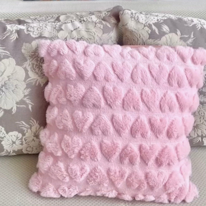 Plush love heart detailed pillow on a sofa