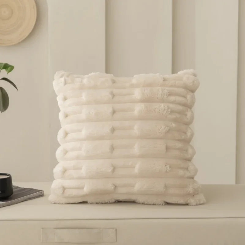 Textured beige cushion on a neutral background