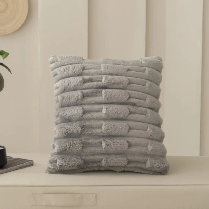 Grey textured cushion on a neutral background