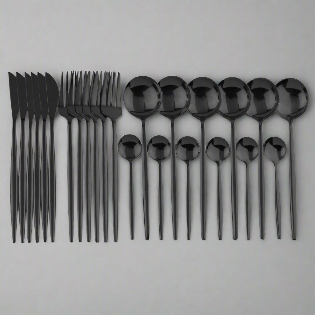 A 24-piece black cutlery set laid out on a white surface, including knives, forks, and spoons with a sleek, modern design.
