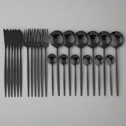 A 24-piece black cutlery set laid out on a white surface, including knives, forks, and spoons with a sleek, modern design.