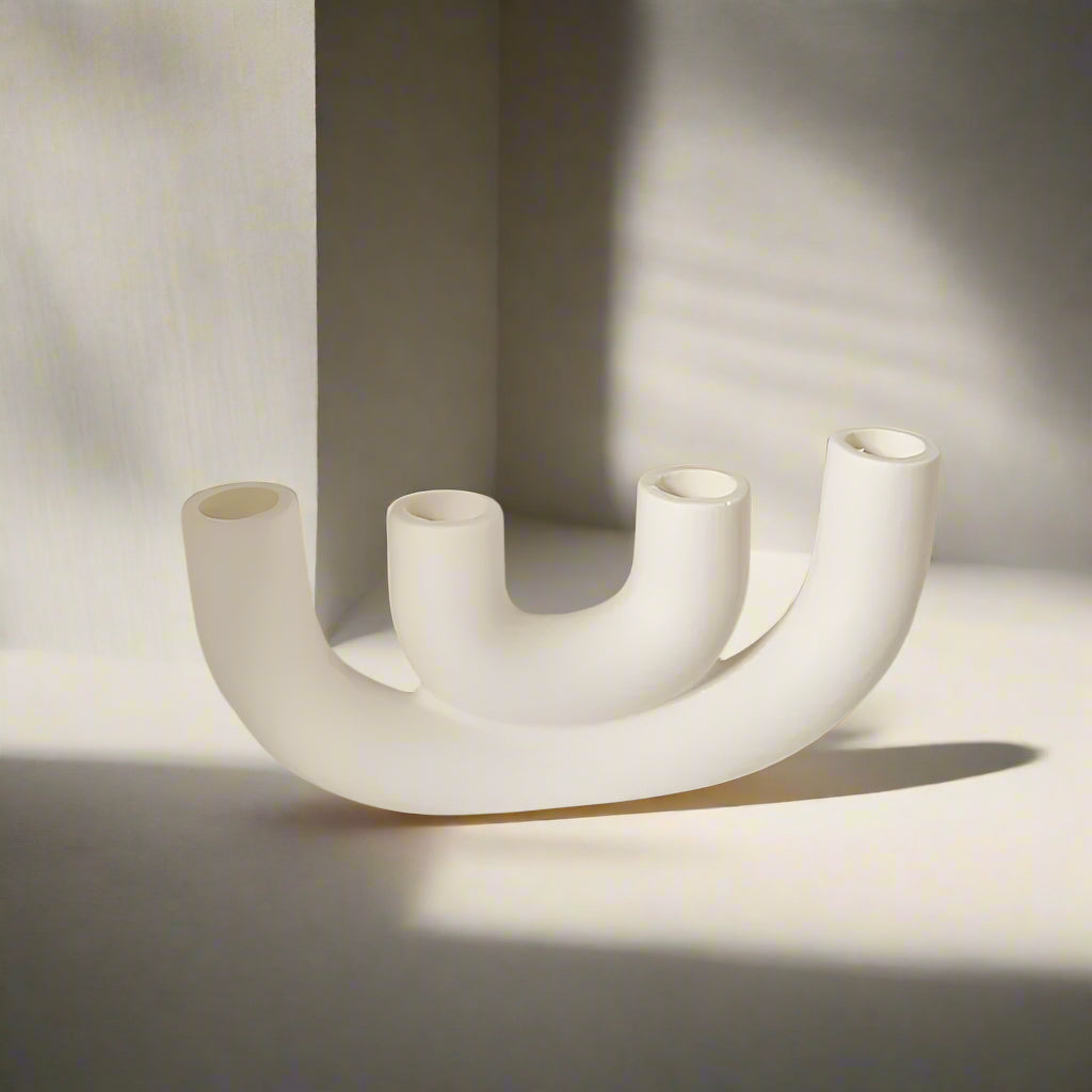 White U-shaped candle holder designed for four candles