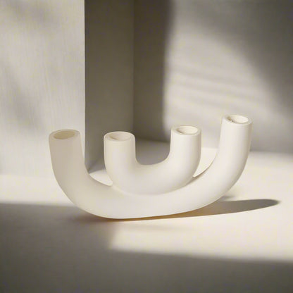 White U-shaped candle holder designed for four candles