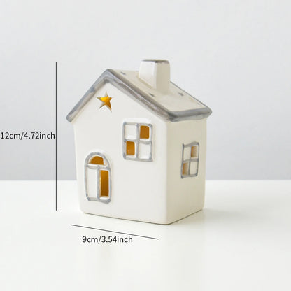 A grey roofed ceramic Christmas house with lights, designed to create a mini Christmas village scene.