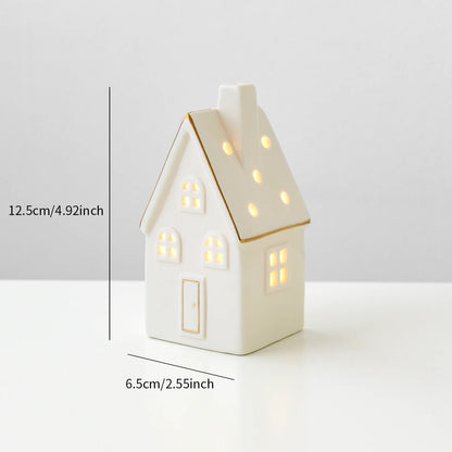 A ceramic Forest Christmas house with lights, designed to create a mini Christmas village scene.