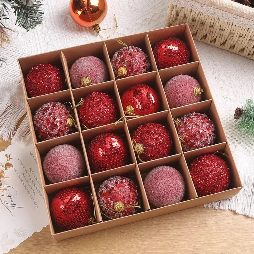 A set of 16 red sparkly, textured Christmas baubles, presented in open cardboard box.
