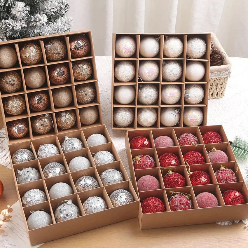 A set of 16 assorted Christmas baubles in a variety of colors, including white, gold, silver, and red, presented in open cardboard boxes.