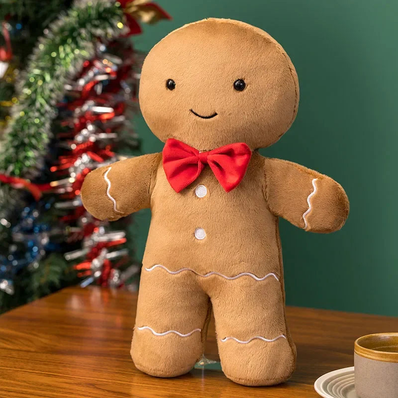 A soft sculptural Christmas plush pillows, shown in the styles of a Gingerbread Man.