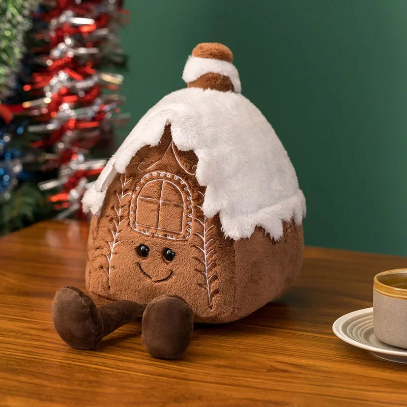 A soft sculptural Christmas plush pillows, shown in the styles of a snow capped house. 
