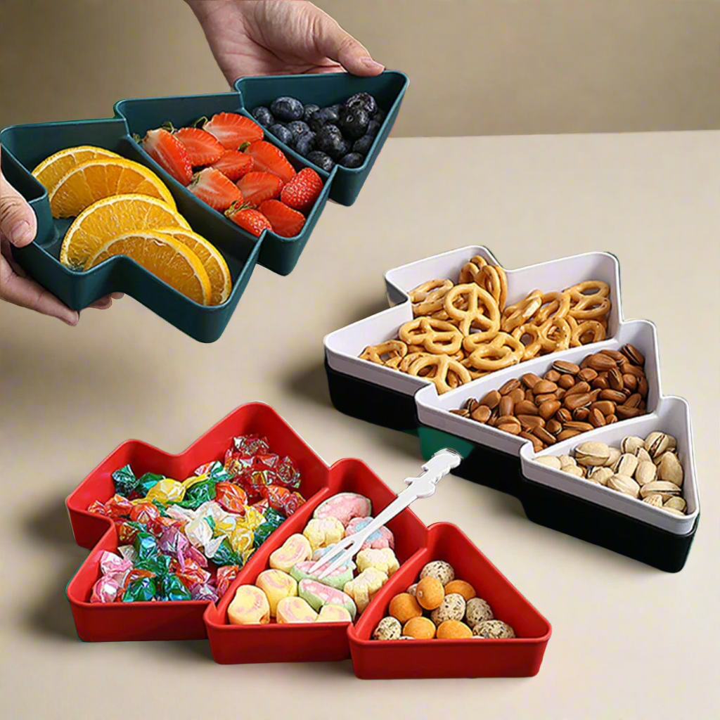 Two Christmas tree-shaped snack plates, one in red, one in white and one in black, filled with various snacks such as fruits, nuts, and sweets.
