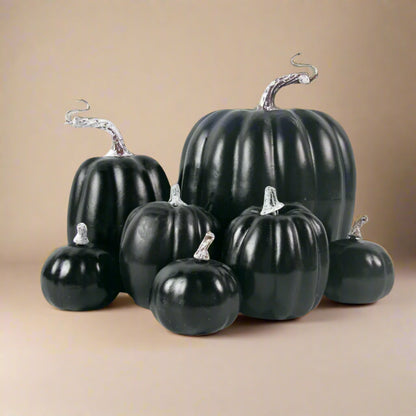 Set of black faux pumpkins on a white background