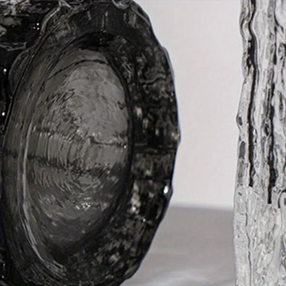 Close-up of a textured smoke grey glass vase base showing the ripple glass effect