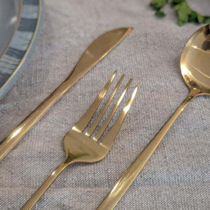 A close up image of a gold cutlery set
