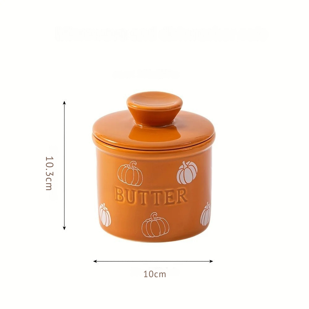 Orange ceramic butter container with measurements on a white background