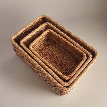 Set of three woven baskets on a white background