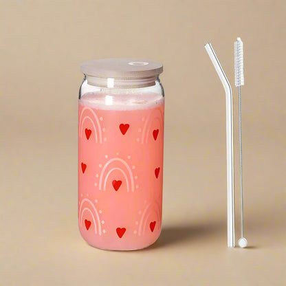 Glass tumblers with heart & rainbow printed design, one pink and one white, with wooden lid and straw. 