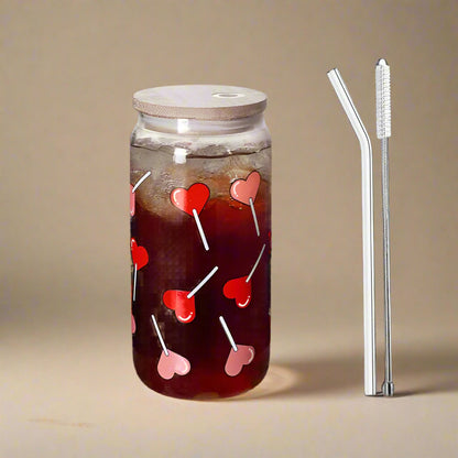 Glass drinking tumblers with heart lolly pop printed design and with bamboo lid and glass straw. 