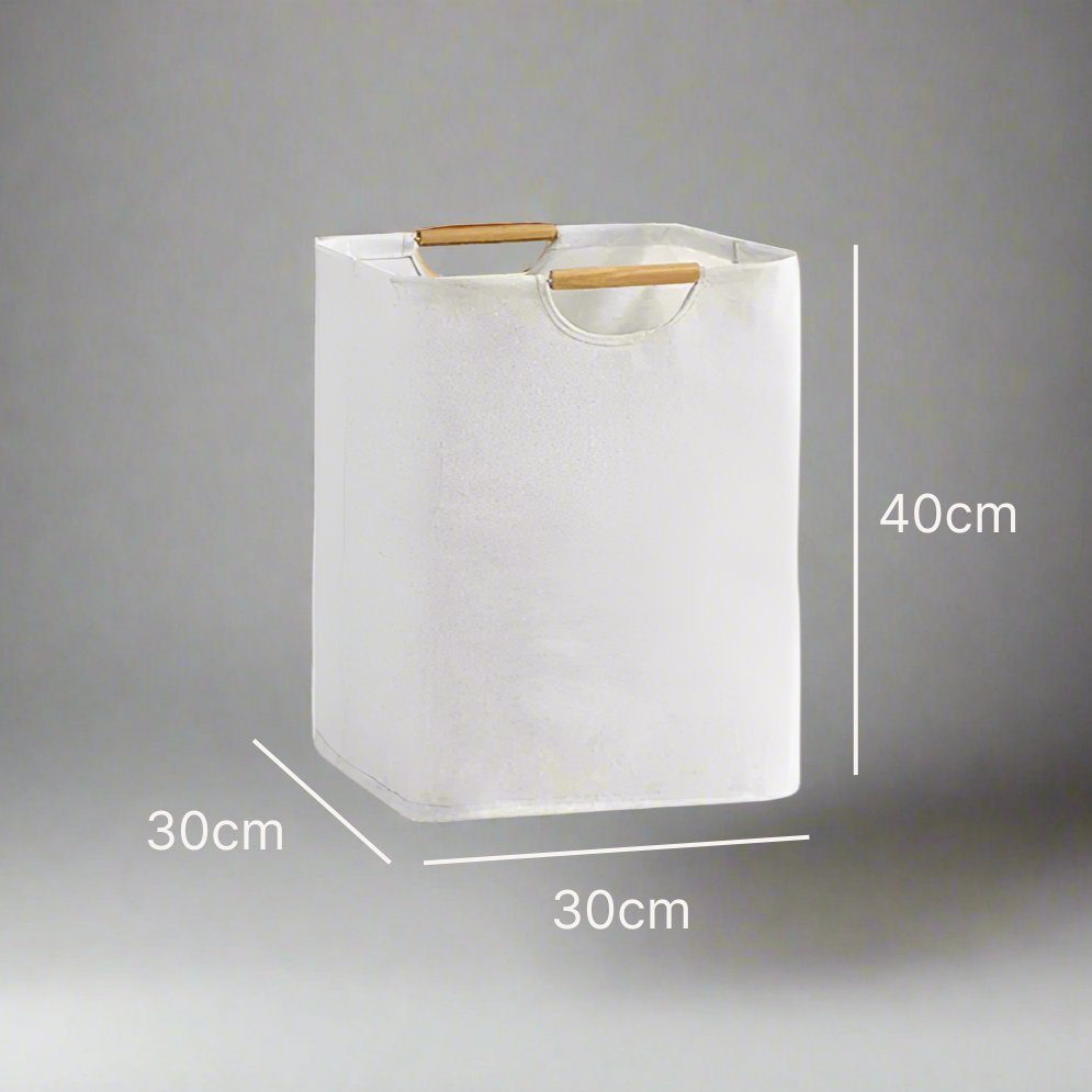 White laundry basket with wooden handle and dimensions on a gray background