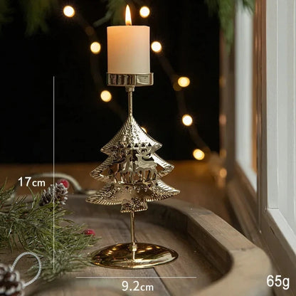 A gold metal candle holder with a festive Christmas tree engraving