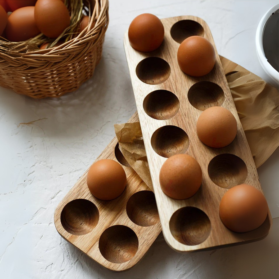 Wooden egg holder with eggs on a light surface