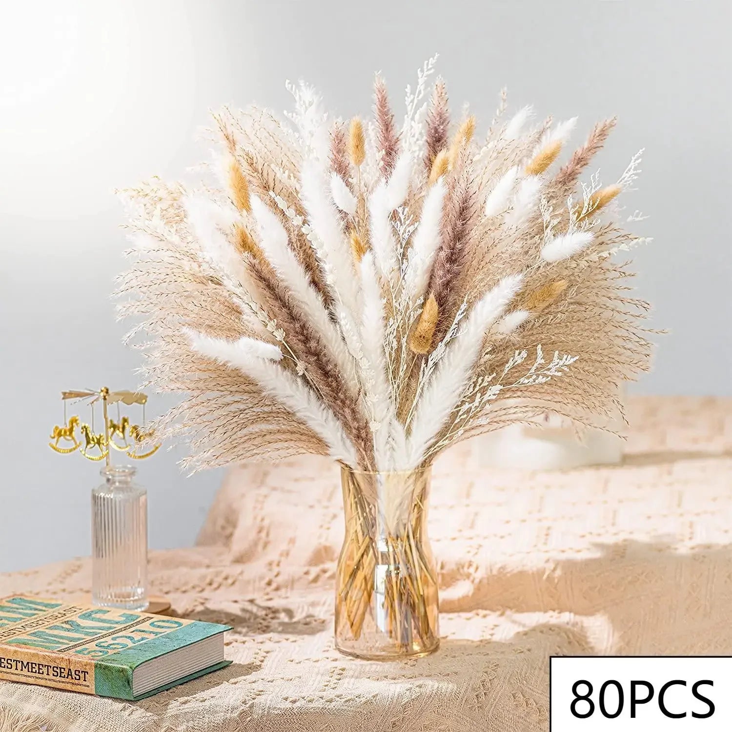 A clear vase of dried pampas grass
