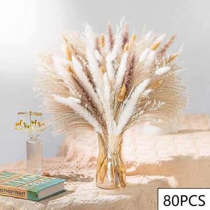 A clear vase of dried pampas grass