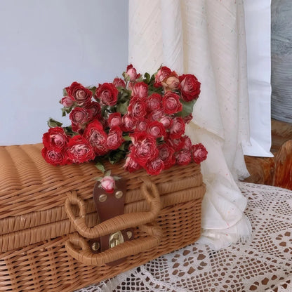 Wicker basket with rosy blend coloured dried roses on a lace tablecloth