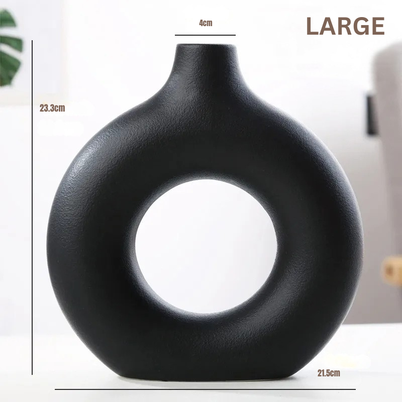 Black nordic vase with circular design and measurements on a white background