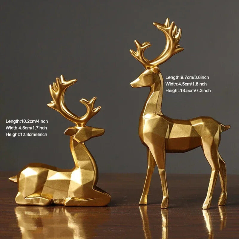 A set of two golden, geometric reindeer ornaments placed on a wooden, glossy surface, with dimensions stated. 