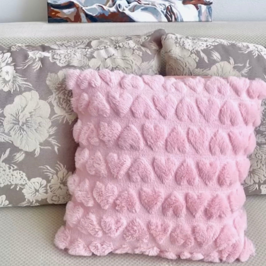 Plush love heart detailed pillow on a sofa