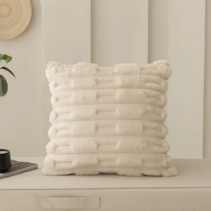 Textured beige cushion on a neutral background