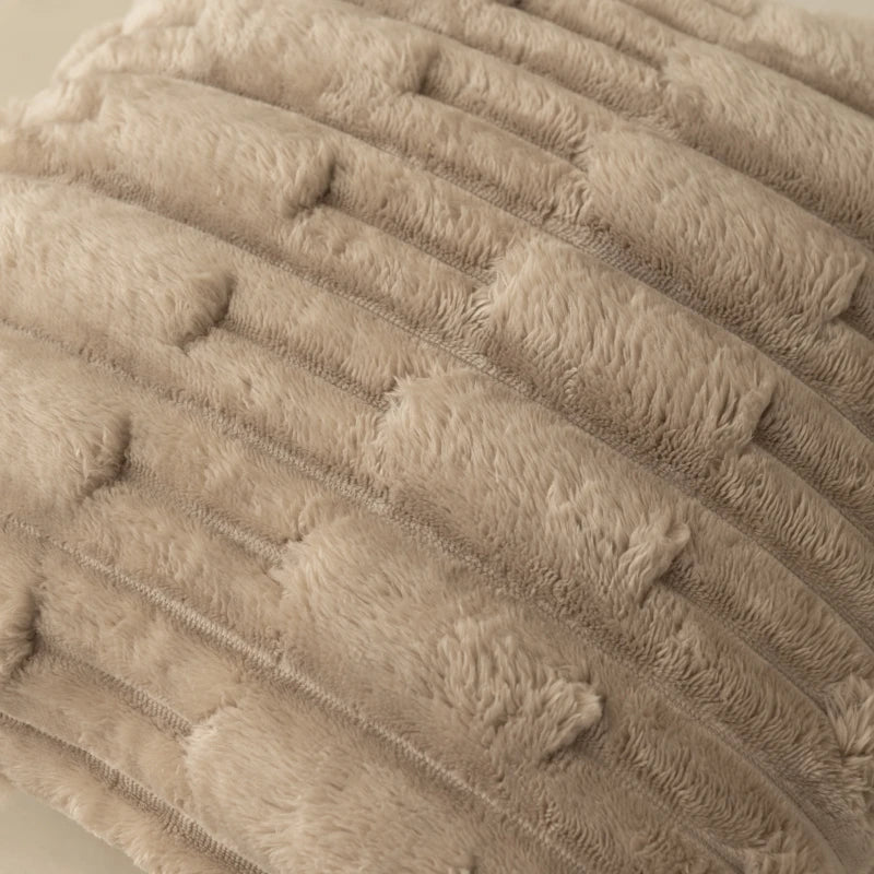 Close-up of a textured beige fabric cushion cover surface