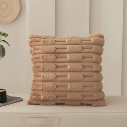 Misty pink textured cushion on a neutral background