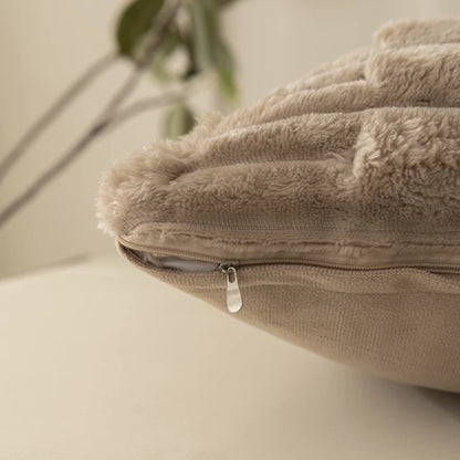Close-up of a beige cushion cover with a zipper on a neutral background