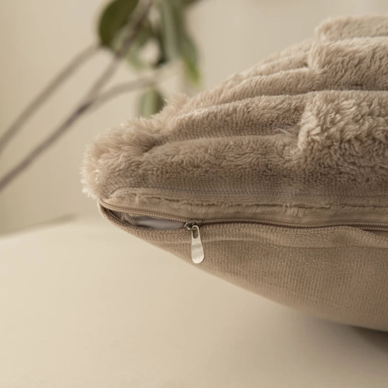 Close-up of a beige cushion cover with a zipper on a neutral background