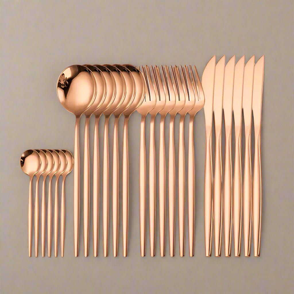 A 24-piece rose gold cutlery set laid out on a beige background, including knives, spoons, forks, and teaspoons.