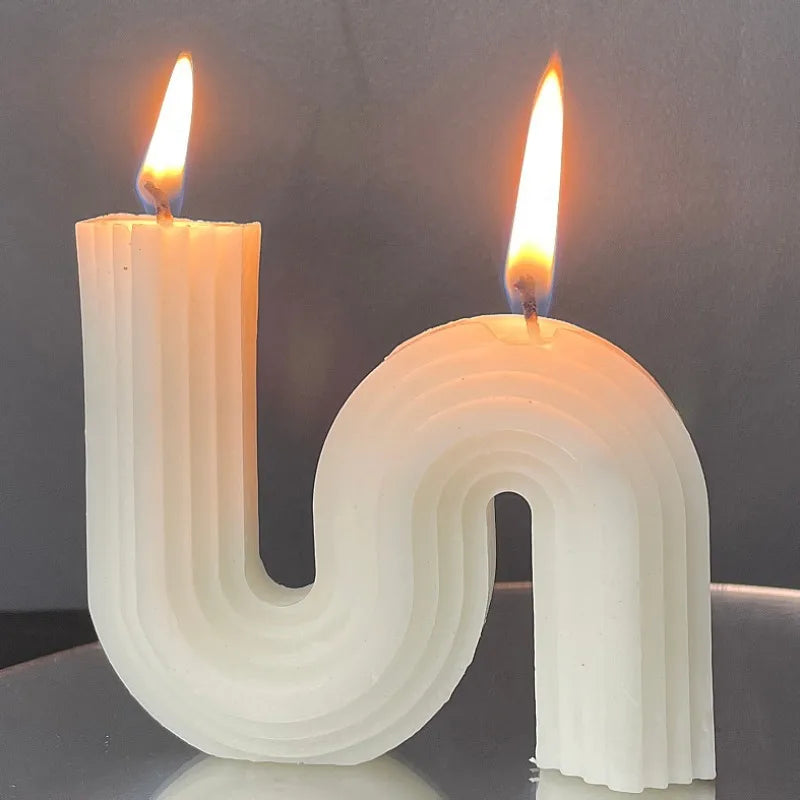 A decorative S-shaped candle made from soy wax in the colour white
