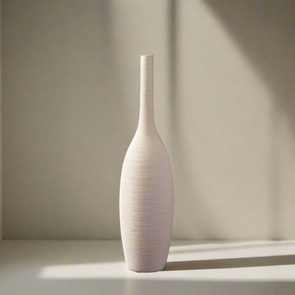White textured vase on a light surface with a neutral background
