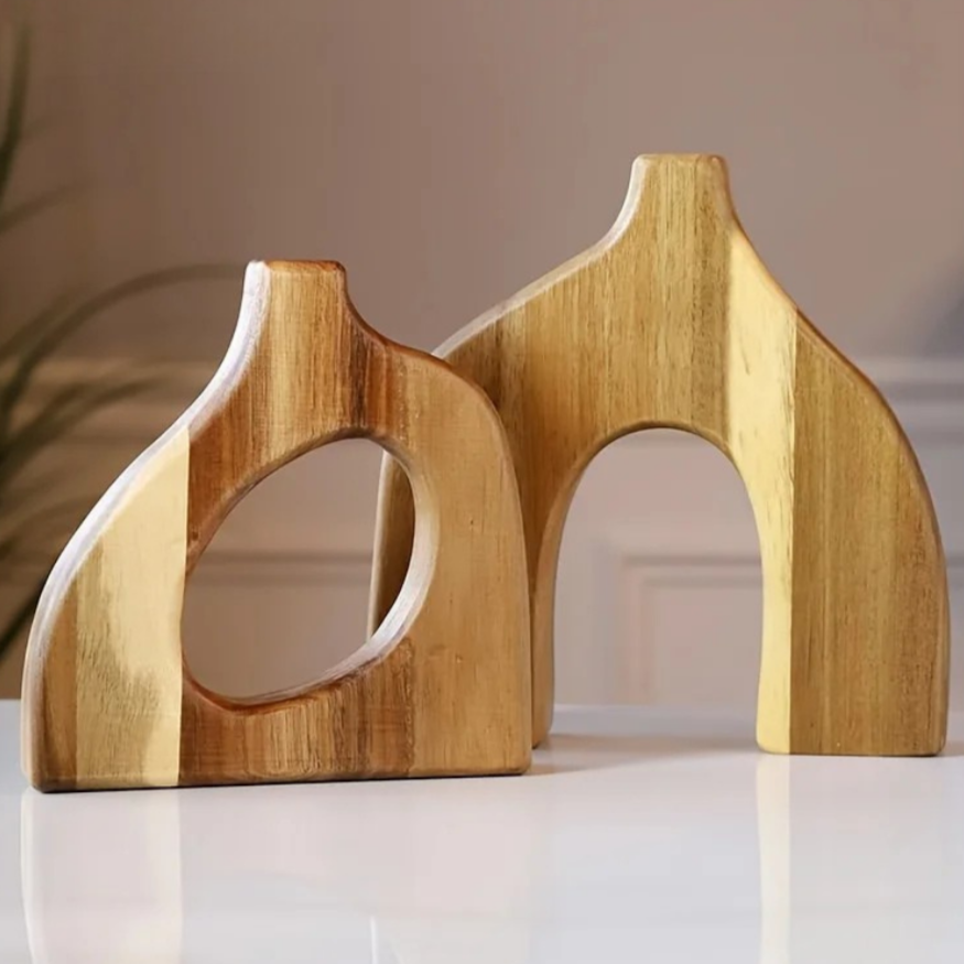 Wooden Nordic vases set on a reflective surface with a neutral background