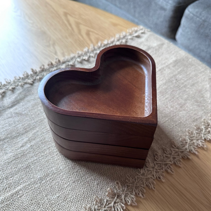 Wooden heart-shaped box on a textured surface