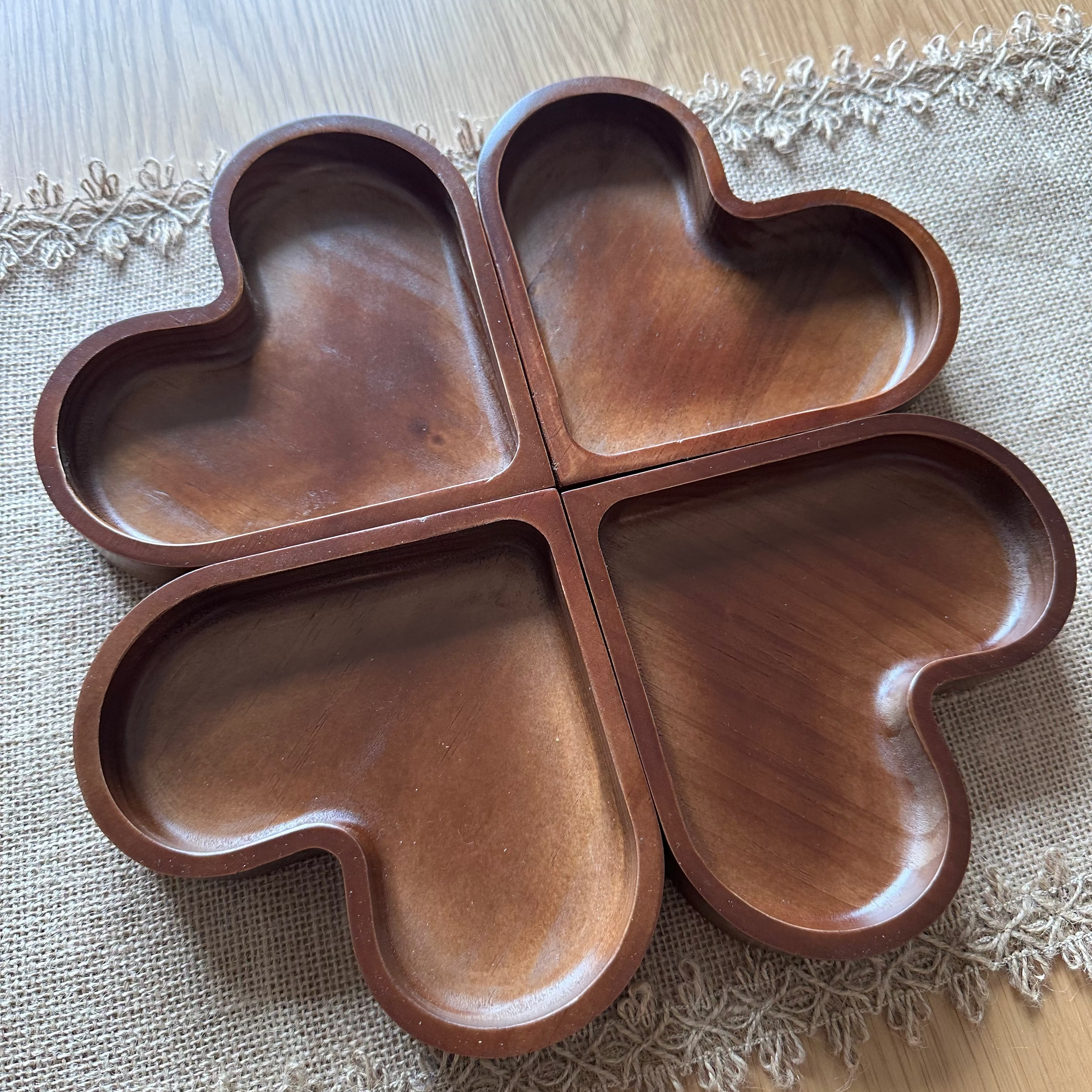 Wooden four-leaf clover shaped tray on a lace tablecloth